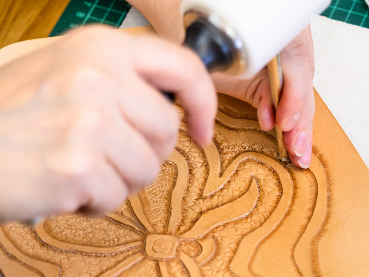 Craftsman Carving the Stamp Design on Leather